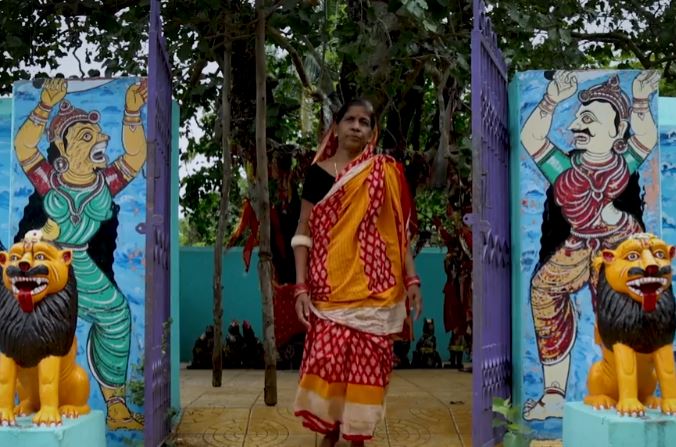 A woman from India walking towards the camera