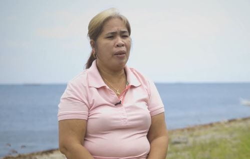 Josie Dequina talking to the camera wearing a pink polo shirt